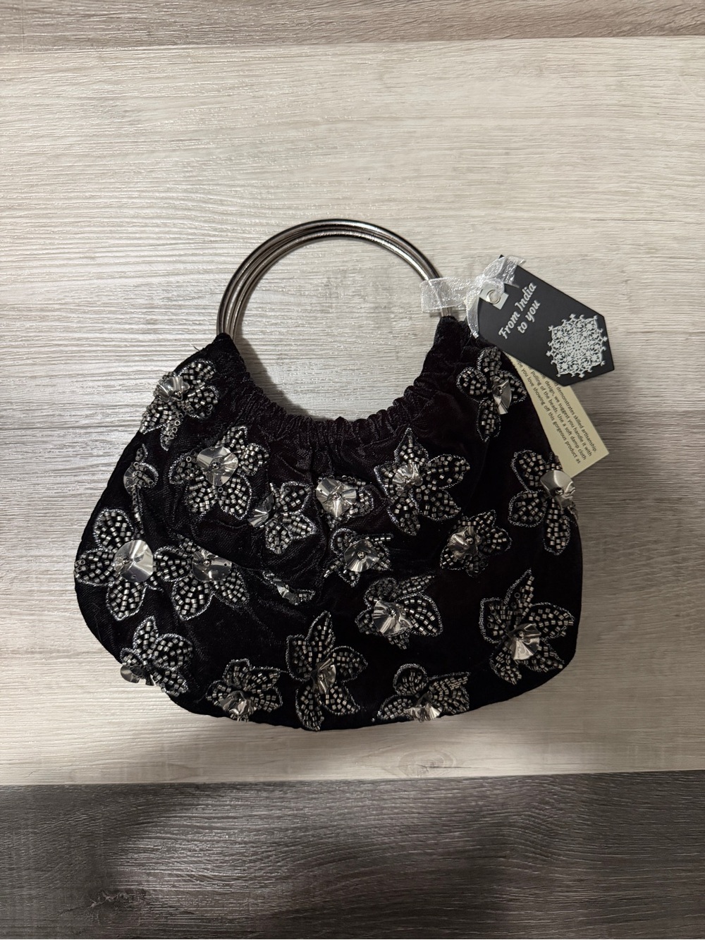Black velvet handbag with silver sequin floral accents